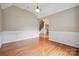 Open living area with hardwood floors, elegant lighting, and decorative wainscoting at 100 Woodwinds Dr, Mount Holly, NC 28120