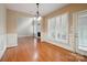 Open living space with a view of the fireplace, shuttered windows, and hardwood flooring at 100 Woodwinds Dr, Mount Holly, NC 28120
