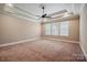 Spacious main bedroom featuring tray ceiling, ceiling fan, neutral walls, and bright windows with shutter blinds at 100 Woodwinds Dr, Mount Holly, NC 28120