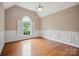 Bright office with hardwood floors, wainscoting, and a large arched window at 100 Woodwinds Dr, Mount Holly, NC 28120