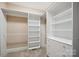 Walk-in closet featuring custom shelving, drawers, and hanging space for optimal organization at 100 Woodwinds Dr, Mount Holly, NC 28120