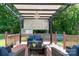 Cozy back deck featuring a pergola, chandelier, string lights, and comfortable outdoor seating area at 103 Poplar Trl, Rockwell, NC 28138