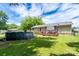 Expansive backyard featuring a well-maintained lawn, above ground pool, and back deck with pergola at 103 Poplar Trl, Rockwell, NC 28138