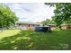 Large backyard featuring an above ground pool, shed, deck, and ample green space at 103 Poplar Trl, Rockwell, NC 28138