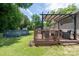 Well-maintained backyard featuring a deck with pergola, an above ground pool, and a storage shed at 103 Poplar Trl, Rockwell, NC 28138