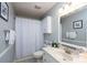 Bathroom with a shower-tub combo and a white single sink vanity at 103 Poplar Trl, Rockwell, NC 28138
