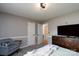Relaxing bedroom with a comfortable bed, dresser with a television, and an inviting gray armchair at 103 Poplar Trl, Rockwell, NC 28138