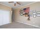 Comfortable bedroom with closet, ceiling fan, and display shelving with framed pictures at 103 Poplar Trl, Rockwell, NC 28138