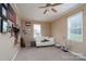 Bright bedroom with ceiling fan, white sofa, and ample display shelving with decorations at 103 Poplar Trl, Rockwell, NC 28138