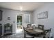 Cozy dining area features a round table, stylish decor, and a door leading to an outdoor deck with a pool at 103 Poplar Trl, Rockwell, NC 28138