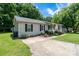 Beautiful single story home with mature trees, a charming front porch, and inviting curb appeal at 103 Poplar Trl, Rockwell, NC 28138