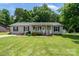 Charming home featuring a well-manicured lawn, cozy front porch, and classic curb appeal at 103 Poplar Trl, Rockwell, NC 28138