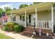 Charming front porch with rocking chairs and patriotic decorations, creating a welcoming entrance at 103 Poplar Trl, Rockwell, NC 28138