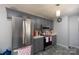 Well-equipped kitchen with stainless steel refrigerator, gray cabinets, and modern appliances at 103 Poplar Trl, Rockwell, NC 28138