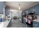 Updated kitchen with gray cabinetry, stainless steel appliances, and adjacent dining area, perfect for modern living at 103 Poplar Trl, Rockwell, NC 28138