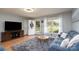 Cozy living room with hardwood floors, a plush rug, and plenty of natural light from the window at 103 Poplar Trl, Rockwell, NC 28138