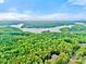 Expansive aerial view of Lake Norman surrounded by lush green trees and partial views of the home at 10300 Sweetleaf Pl, Charlotte, NC 28278
