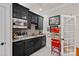Basement bar with dark wood cabinetry, stainless steel microwave, wine storage, and a popcorn machine at 10300 Sweetleaf Pl, Charlotte, NC 28278