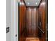 Wood paneled residential elevator featuring a wood floor and metal trim at 10300 Sweetleaf Pl, Charlotte, NC 28278