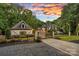 Elegant home with a gated entrance, manicured landscaping, and a charming guest house at 10300 Sweetleaf Pl, Charlotte, NC 28278