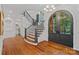 Grand foyer features hardwood floors, arched entryway, and an elegant staircase with iron railing at 10300 Sweetleaf Pl, Charlotte, NC 28278