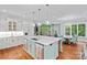 Bright kitchen with a large island, stainless steel appliances, and open floor plan at 10300 Sweetleaf Pl, Charlotte, NC 28278