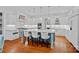 Bright kitchen features a large island with seating, pendant lighting, and stainless steel appliances at 10300 Sweetleaf Pl, Charlotte, NC 28278