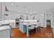 Bright kitchen features a large island with seating, pendant lighting, and stainless steel appliances at 10300 Sweetleaf Pl, Charlotte, NC 28278