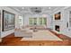 Spacious living room with fireplace, coffered ceiling, and access to the backyard at 10300 Sweetleaf Pl, Charlotte, NC 28278