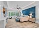 Main bedroom with tray ceiling, large windows, and accent wall behind bed at 10300 Sweetleaf Pl, Charlotte, NC 28278