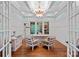 Bright office space featuring hardwood floors, paneled walls, coffered ceilings, and a large window at 10300 Sweetleaf Pl, Charlotte, NC 28278