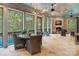 Screened porch with a stone fireplace, outdoor seating, and a view of the trees at 10300 Sweetleaf Pl, Charlotte, NC 28278