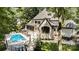Stunning rear exterior view of the house highlighting the pool, patio, and manicured landscaping at 10300 Sweetleaf Pl, Charlotte, NC 28278