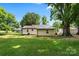 Expansive backyard featuring mature trees with a charming single-story home at 1055 Laurel Ave, Lancaster, SC 29720