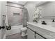 Bright bathroom with vanity, sliding doors, shower, and gray tiled wall at 1055 Laurel Ave, Lancaster, SC 29720