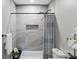 Modern bathroom featuring shower, gray tile walls, and a convenient built-in niche at 1055 Laurel Ave, Lancaster, SC 29720