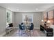 Bright dining room with a glass table, blue velvet chairs and modern decor at 1055 Laurel Ave, Lancaster, SC 29720