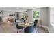 Bright dining area with modern table setting, view into open living room at 1055 Laurel Ave, Lancaster, SC 29720