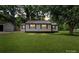Charming single-story home with a metal roof, complemented by a well-manicured lawn and mature trees at 1055 Laurel Ave, Lancaster, SC 29720