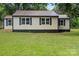 Quaint single-story home featuring a metal roof, fresh exterior paint and manicured lawn at 1055 Laurel Ave, Lancaster, SC 29720