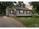 Well-maintained home with fresh landscaping and a gravel driveway at 1055 Laurel Ave, Lancaster, SC 29720