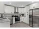 Bright kitchen features stainless steel appliances and crisp white cabinetry at 1055 Laurel Ave, Lancaster, SC 29720