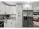 Bright kitchen features stainless steel refrigerator and white cabinets at 1055 Laurel Ave, Lancaster, SC 29720