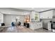 Open concept living space features a dining area and white kitchen with granite countertops at 1055 Laurel Ave, Lancaster, SC 29720