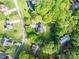 A beautiful aerial view highlighting the large lot, mature trees, and outdoor living spaces at 107 Ingonish Dr, Gastonia, NC 28056