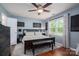 Comfortable bedroom featuring hardwood floors, a ceiling fan, and a large window providing natural light at 107 Ingonish Dr, Gastonia, NC 28056
