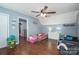 Spacious bedroom with hardwood floors, a ceiling fan, and space for multiple beds and play areas at 107 Ingonish Dr, Gastonia, NC 28056