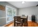 Bright dining area featuring hardwood floors and a large window providing ample natural light at 107 Ingonish Dr, Gastonia, NC 28056