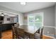 Cozy dining area features a wooden table and chairs with large window bringing in natural light at 107 Ingonish Dr, Gastonia, NC 28056