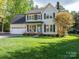Charming two-story home featuring a well-manicured lawn, attached garage, and inviting front porch at 107 Ingonish Dr, Gastonia, NC 28056